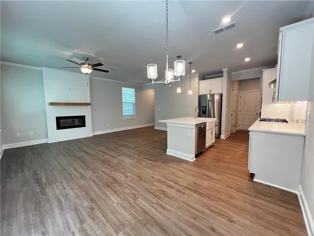a view of a kitchen with a sink cabinets and wooden floor