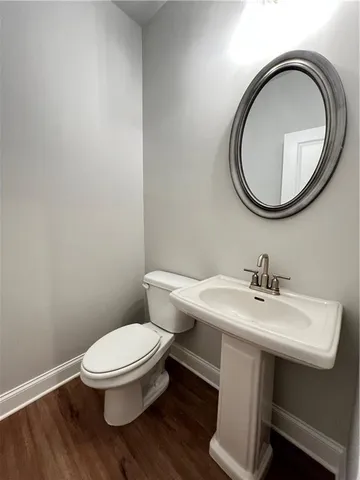 a white toilet sitting next to a bathroom sink
