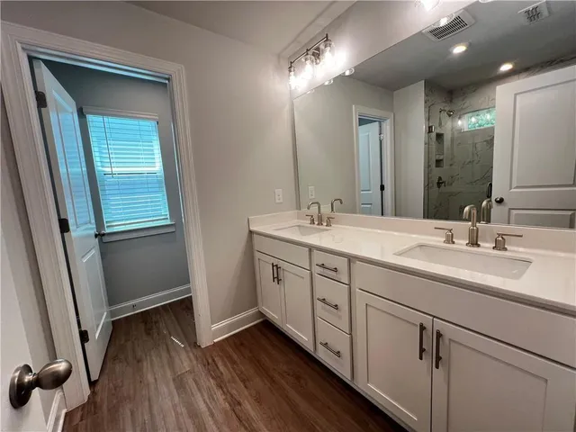 a bathroom with a double vanity sink and mirror