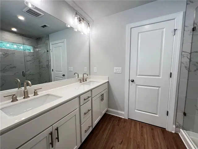 a bathroom with a double vanity sink and a mirror