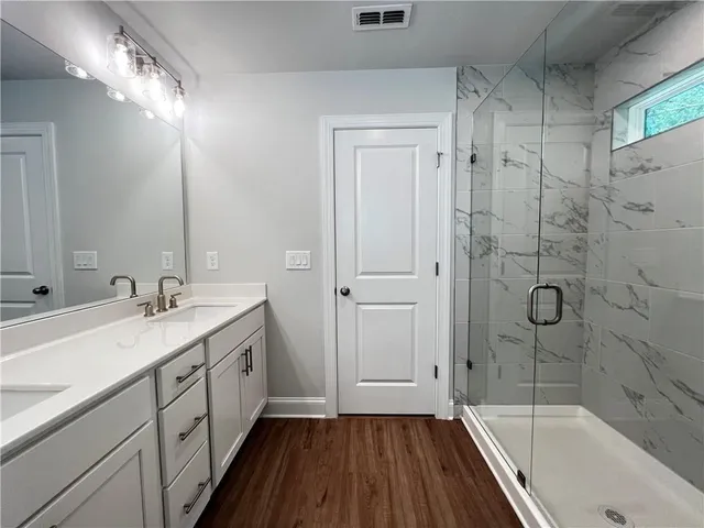 a bathroom with a sink a mirror and a bathtub