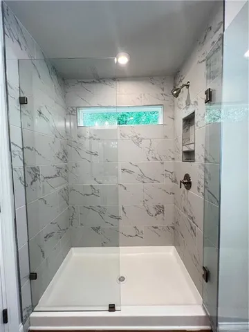 a bathroom with a bathtub and a shower