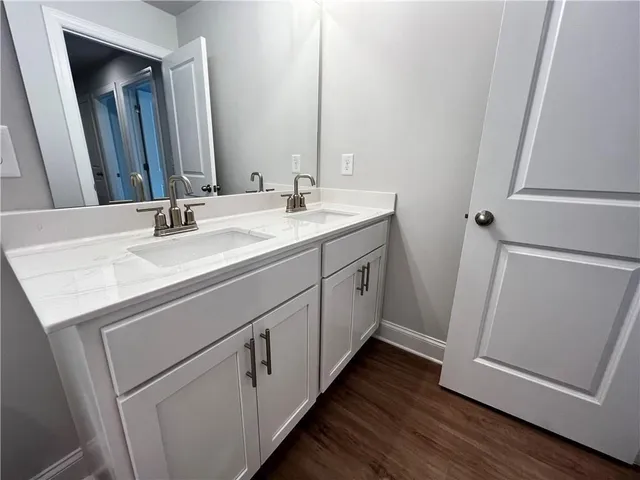 a bathroom with a double vanity sink and mirror