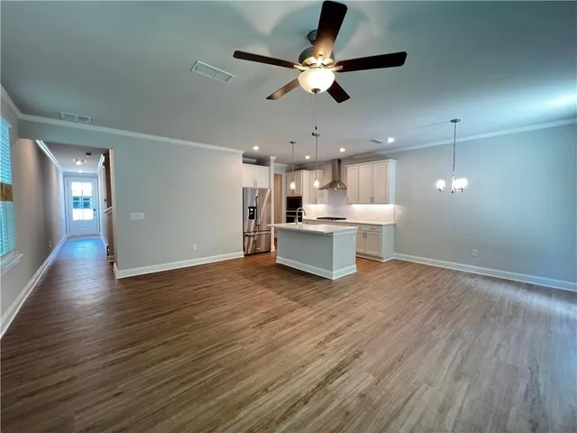 a view of a kitchen with a stove cabinets and wooden floor