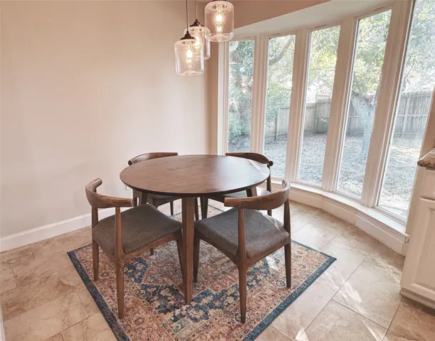 a view of a dining room with furniture wooden floor and a chandelier