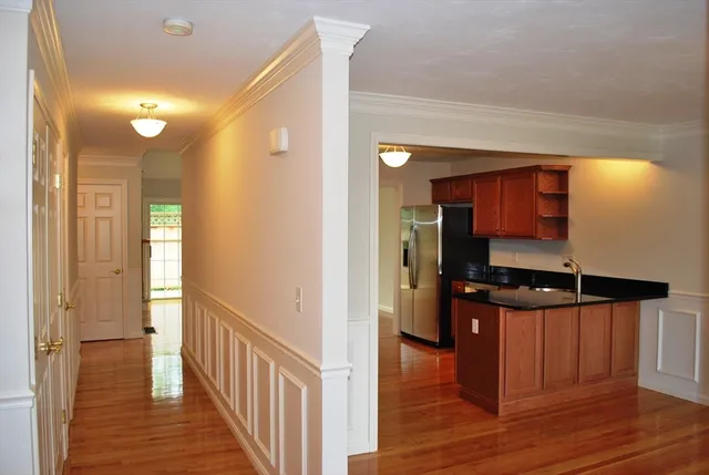 a view of hallway with wooden floor