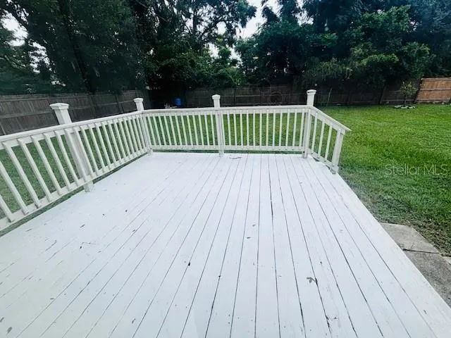 a view of deck with wooden floor and fence