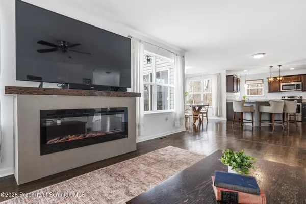 a living room with furniture and a view of kitchen