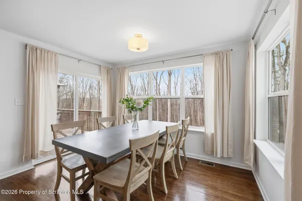 a view of a dining room with furniture and wooden floor