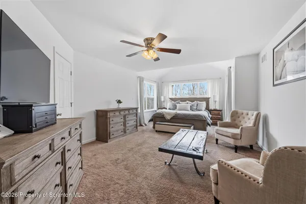 a spacious bathroom with a double vanity sink a mirror and a