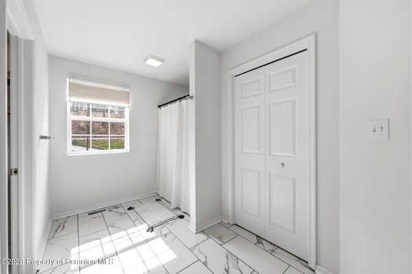 a spacious bedroom with a bed and a window