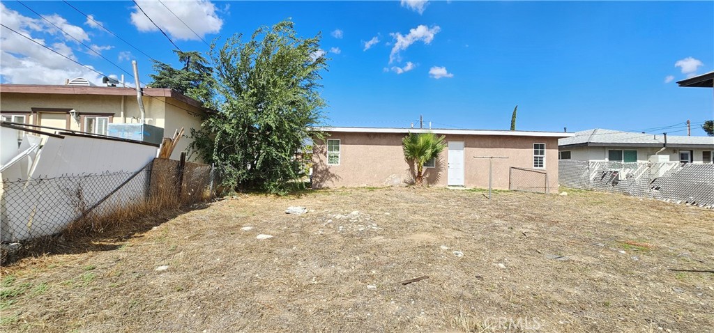 1530 East Jacinto View Road Banning, CA 92220 - Photo 8 of 9 a backyard of a house with plants and wooden fence