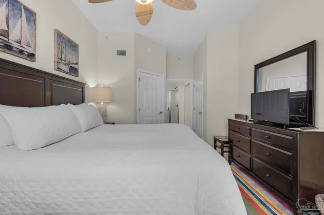 a bedroom with a bed and a flat screen tv