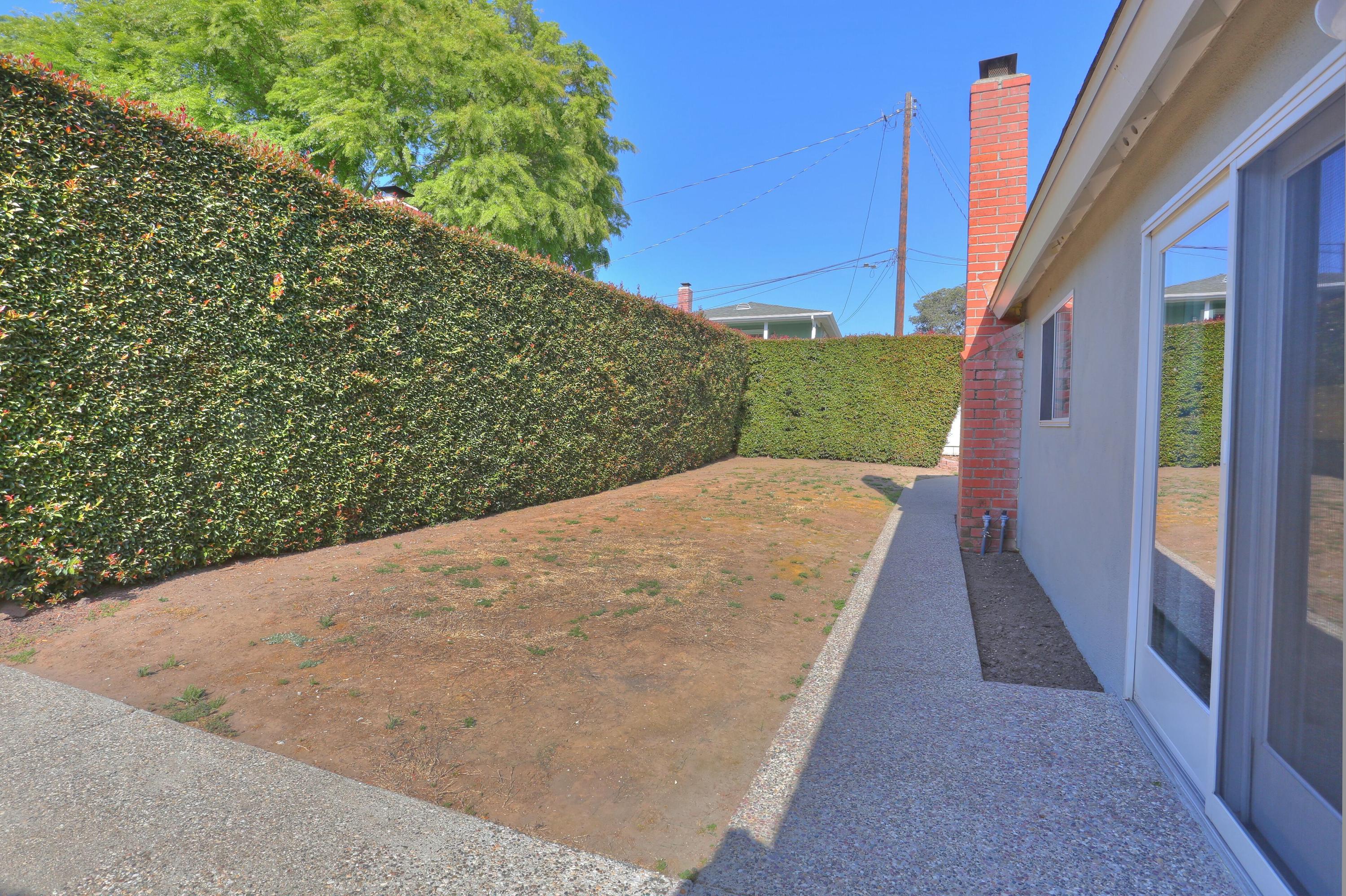 5668 Encina Road Goleta, CA 93117 - Photo 13 of 16 a view of a backyard with pathway