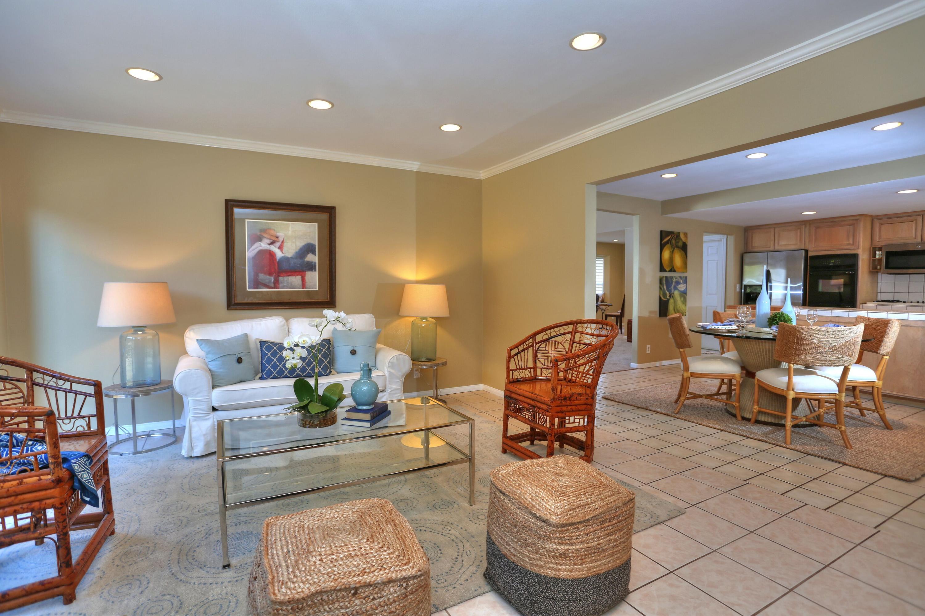 5668 Encina Road Goleta, CA 93117 - Photo 3 of 16 a living room with furniture and a lamp