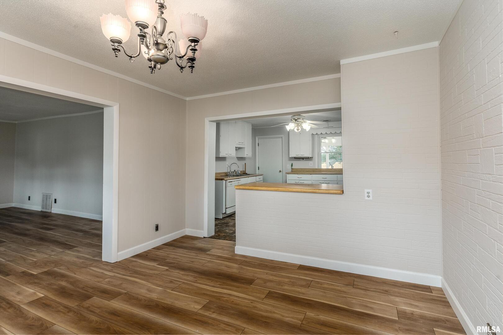 53 Private Road De Soto, IL 62924 - Photo 11 of 38 a view of a kitchen and a sink wooden floor chandelier
