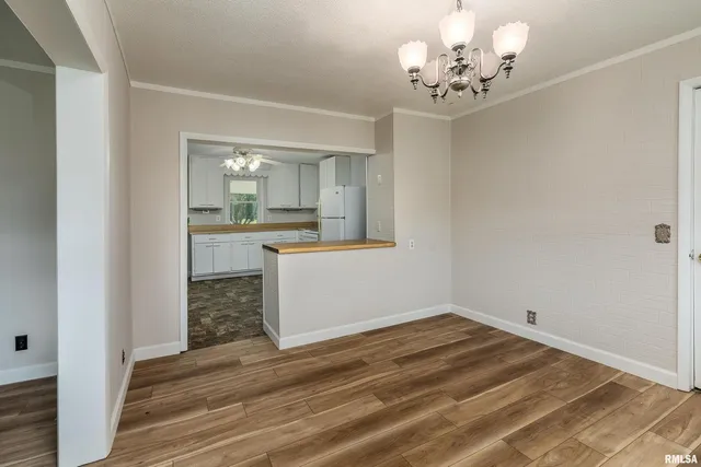 a view of a kitchen and a sink wooden floor chandelier