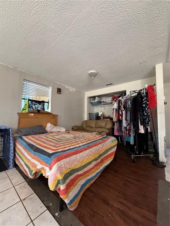 6100 Main Street, Unit A New Port Richey, FL 34653 - Photo 18 of 23 a bedroom with bed and a closet