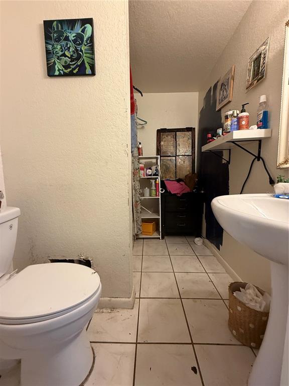 6100 Main Street, Unit A New Port Richey, FL 34653 - Photo 19 of 23 a bathroom with a toilet and a sink