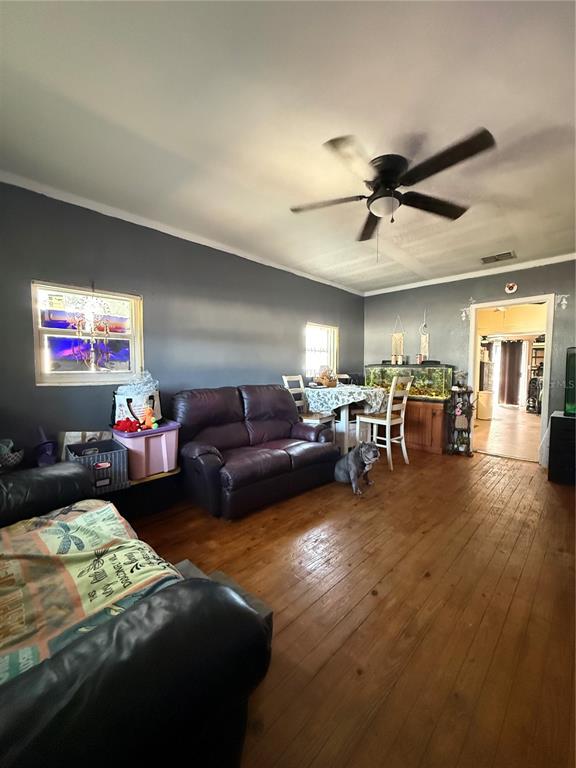 6100 Main Street, Unit A New Port Richey, FL 34653 - Photo 3 of 23 a bedroom with furniture and a chandelier