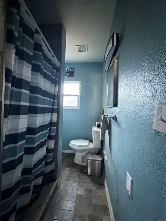 6100 Main Street, Unit A New Port Richey, FL 34653 - Photo 8 of 23 a bathroom with a sink toilet and shower