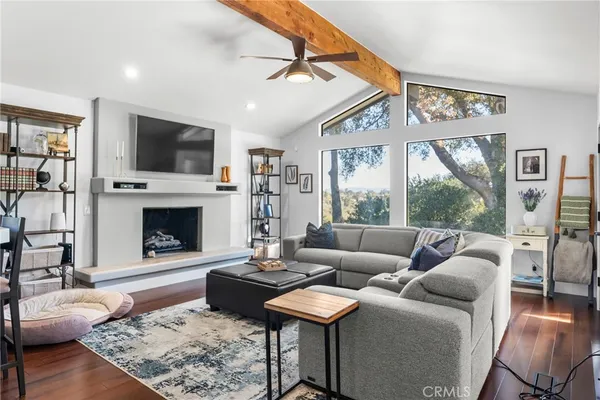 a living room with furniture a flat screen tv and a fireplace