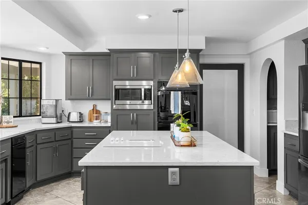 a kitchen with stainless steel appliances granite countertop a sink and a stove
