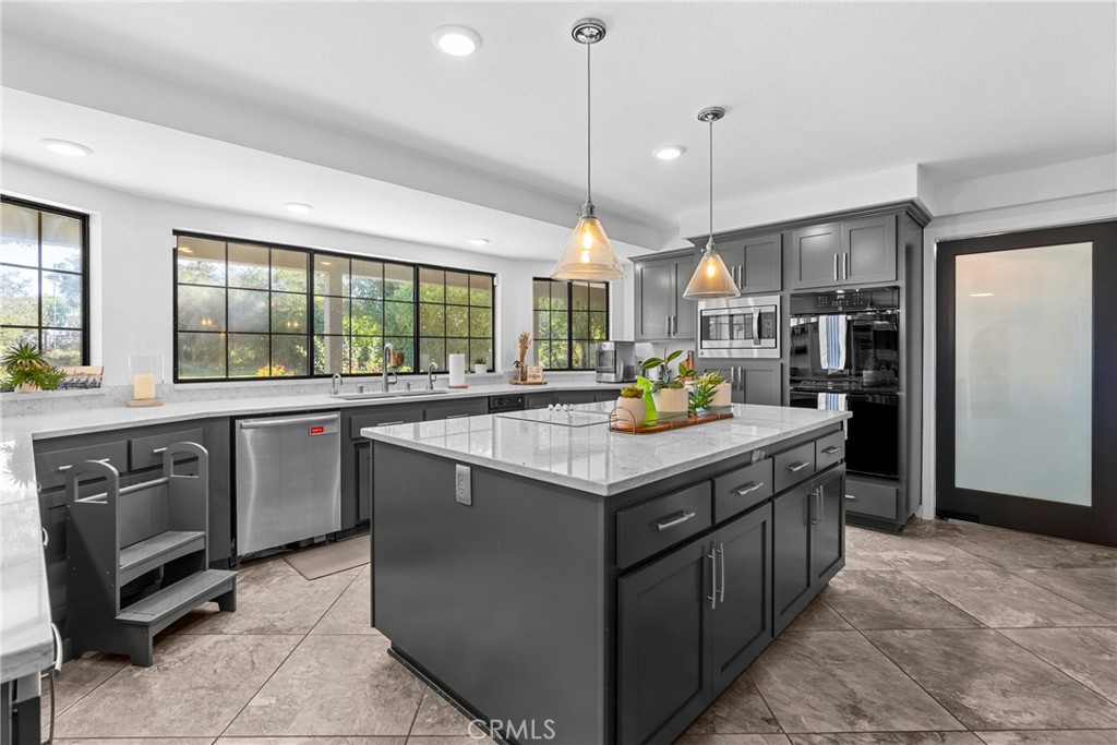 5750 Robin Court Santa Maria, CA 93455 - Photo 23 of 56 a kitchen with stainless steel appliances granite countertop a sink and a stove