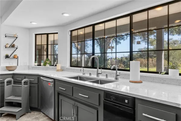 a kitchen with stainless steel appliances kitchen island a sink a refrigerator and cabinets