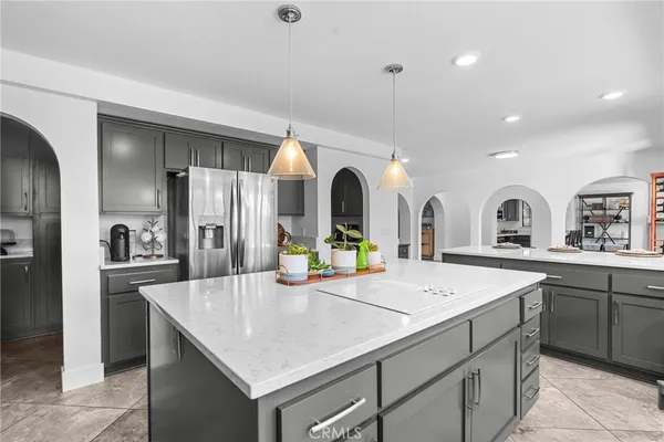 a kitchen with stainless steel appliances granite countertop a stove and a refrigerator
