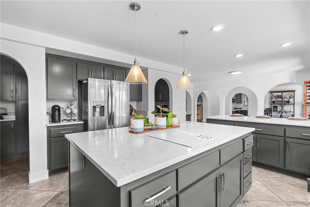 5750 Robin Court Santa Maria, CA 93455 - Photo 26 of 56 a kitchen with stainless steel appliances kitchen island a sink a refrigerator and cabinets