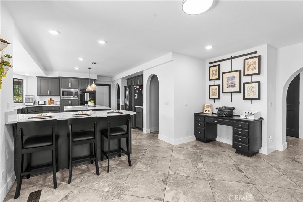 5750 Robin Court Santa Maria, CA 93455 - Photo 27 of 56 a kitchen with stainless steel appliances granite countertop a stove and a refrigerator