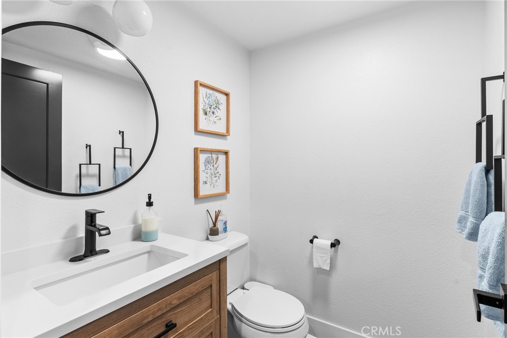 5750 Robin Court Santa Maria, CA 93455 - Photo 32 of 56 a bathroom with a toilet a sink and mirror