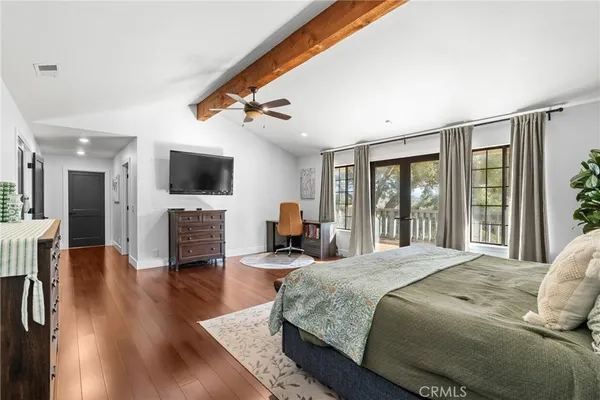 a spacious bathroom with a tub double sink and a mirror