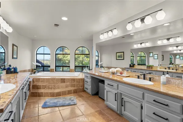 a large kitchen with a lot of counter space and a wooden floor