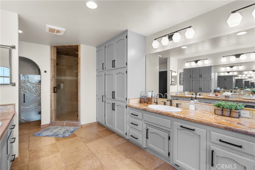 5750 Robin Court Santa Maria, CA 93455 - Photo 40 of 56 a spacious bathroom with a granite countertop sink mirror and shower