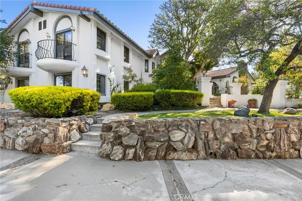 a front view of a house with garden