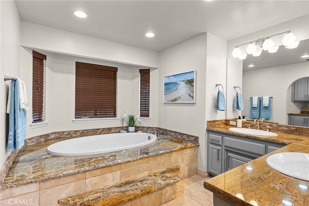 5750 Robin Court Santa Maria, CA 93455 - Photo 43 of 56 a spacious bathroom with a tub double sink and a mirror