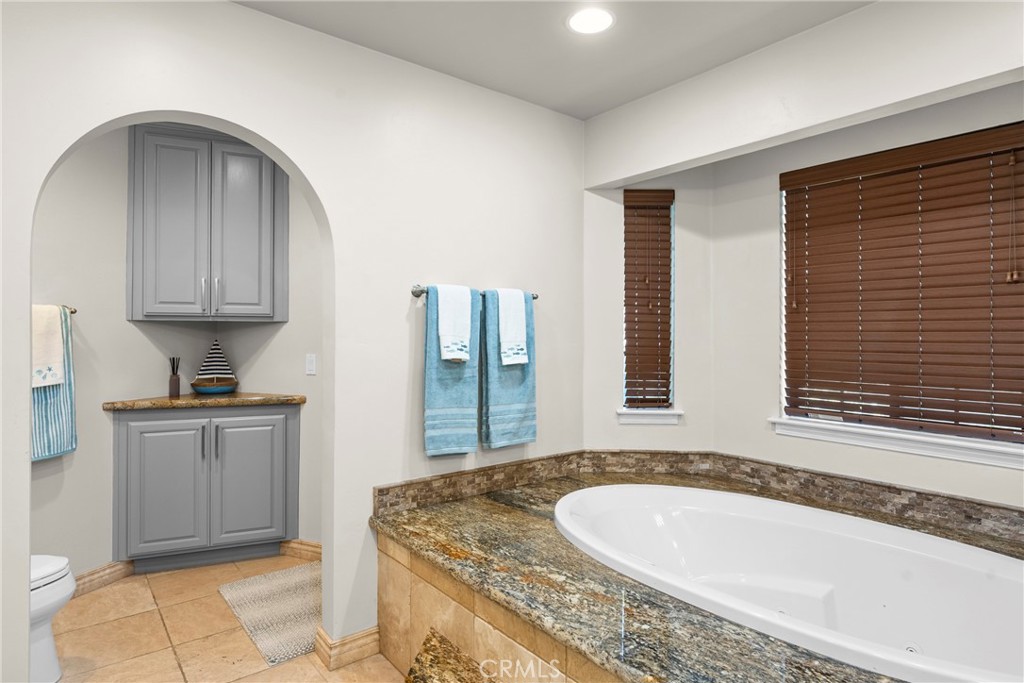 5750 Robin Court Santa Maria, CA 93455 - Photo 45 of 56 a bathroom with a granite countertop tub sink and mirror