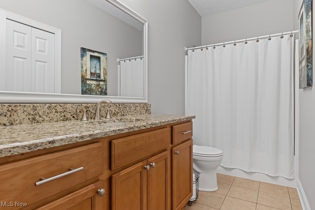 369 Eldridge Road Aurora, OH 44202 - Photo 23 of 50 Full bath with vanity, tile patterned flooring, and a textured ceiling