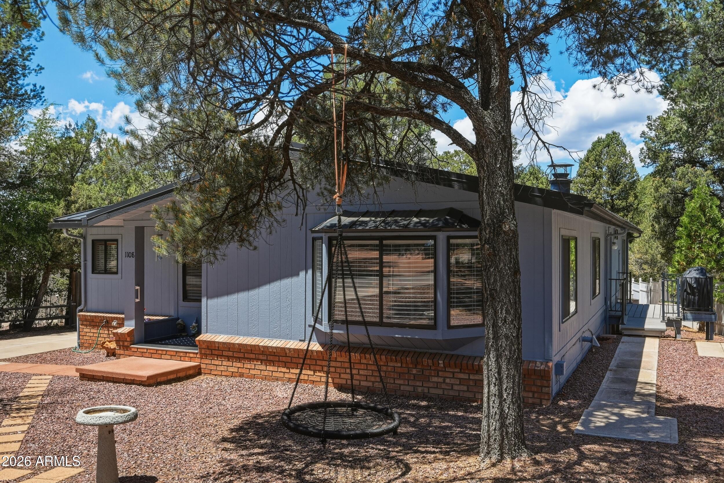 1108 North William Tell Circle Payson, AZ 85541 - Photo 6 of 32 a front view of a house with garden