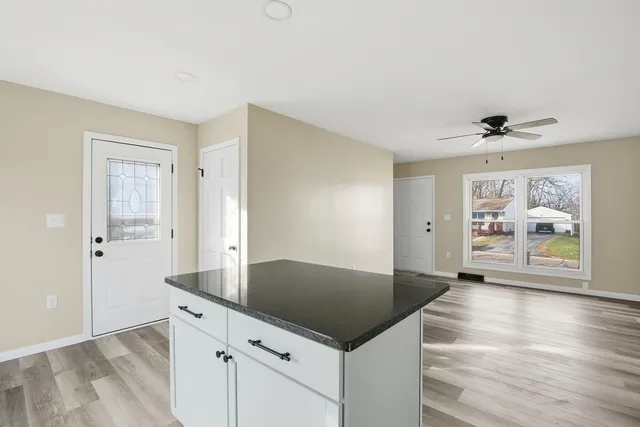 a view of kitchen with cabinets and wooden floor