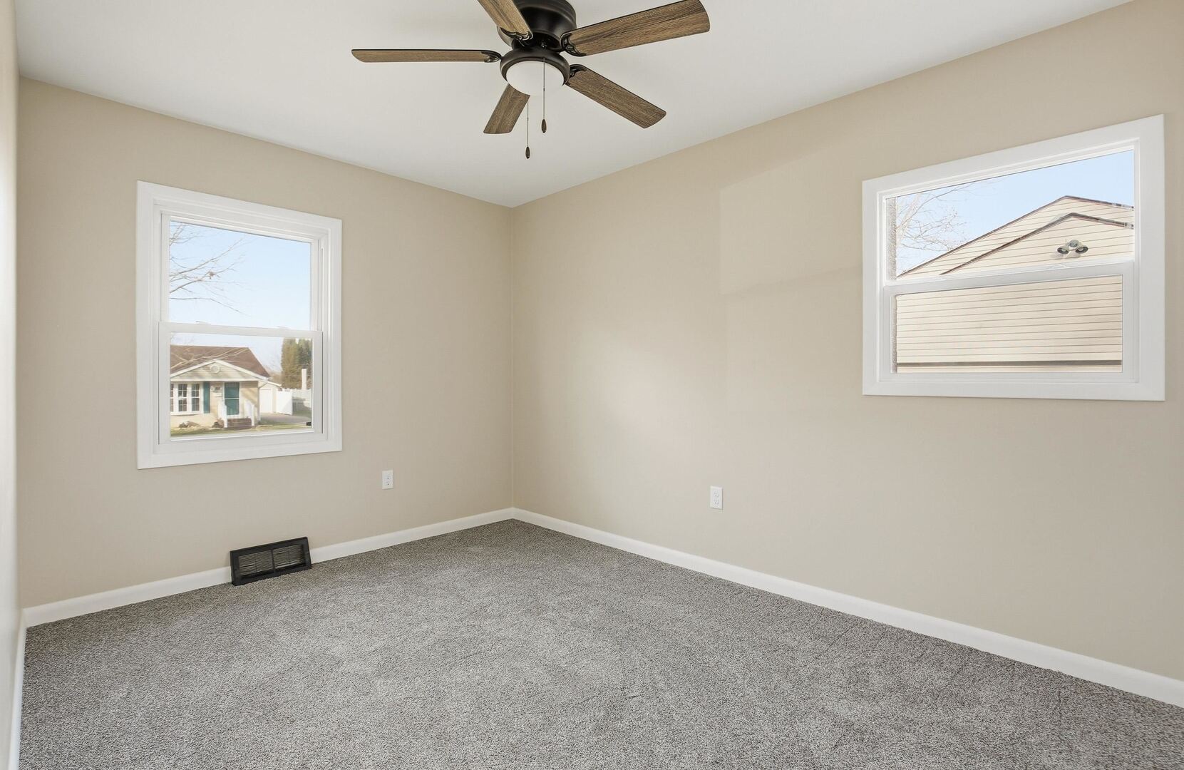 1135 6th Street West Milan, IL 61264 - Photo 13 of 36 an empty room with windows and fan