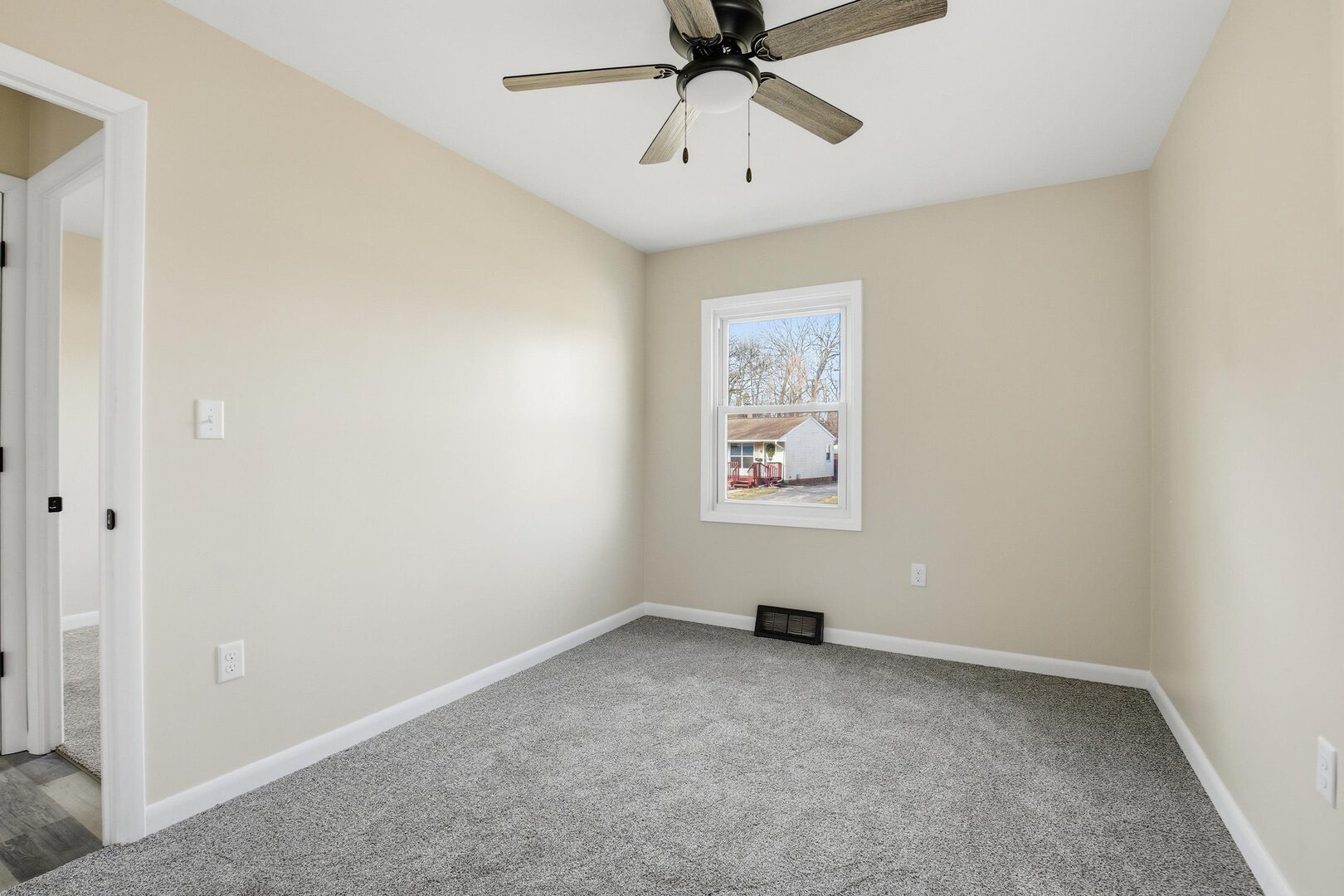 1135 6th Street West Milan, IL 61264 - Photo 14 of 36 an empty room with chandelier fan
