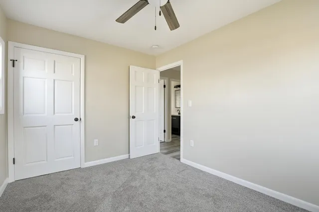 an empty room with a ceiling fan