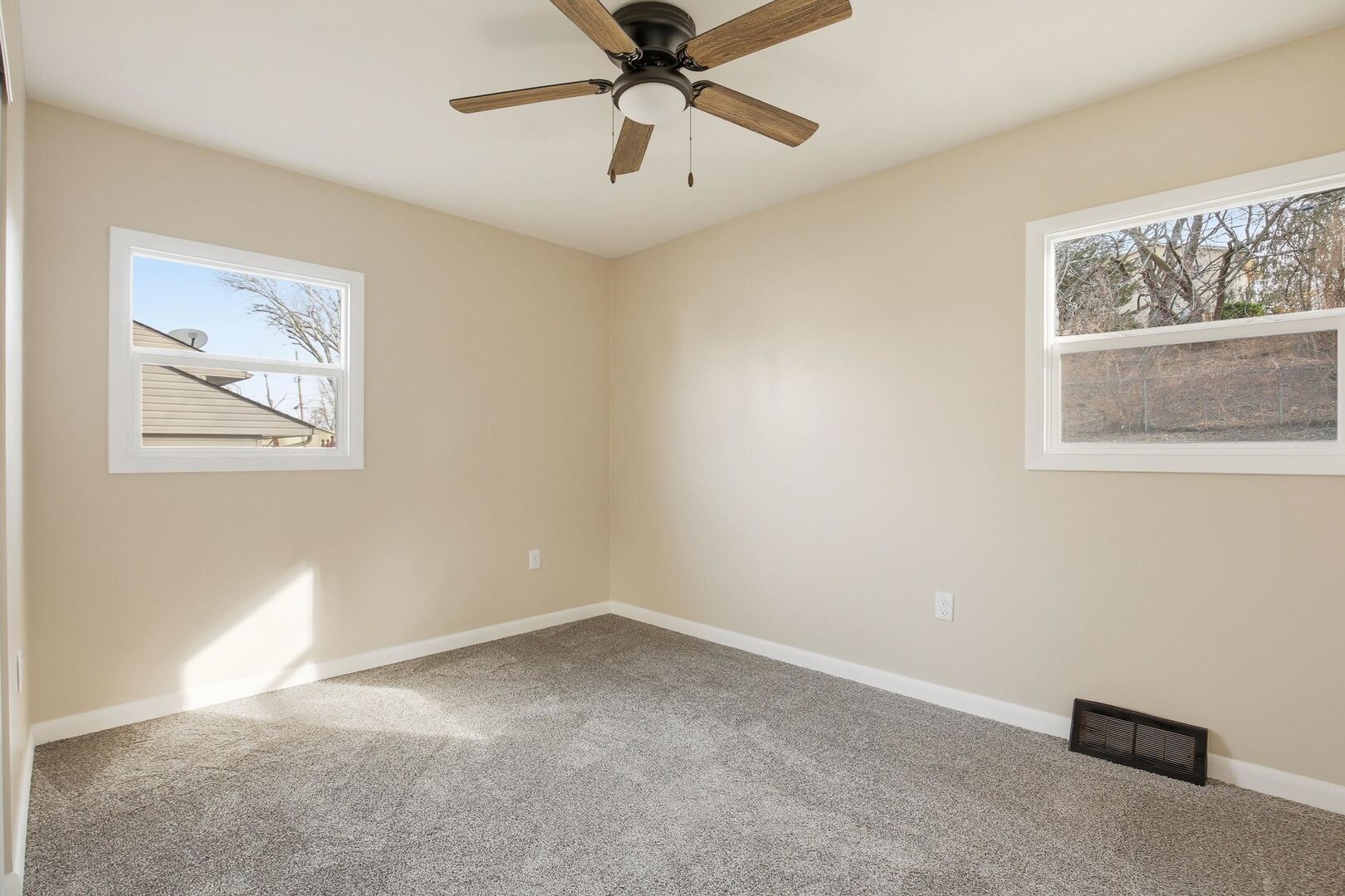 1135 6th Street West Milan, IL 61264 - Photo 16 of 36 a view of an empty room with a window and a ceiling fan