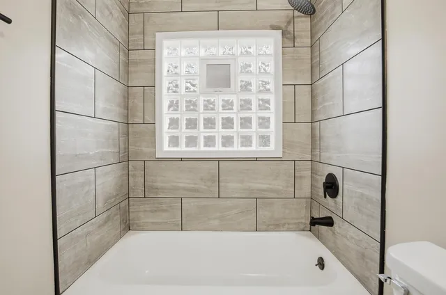 a bathroom with a bathtub and shower