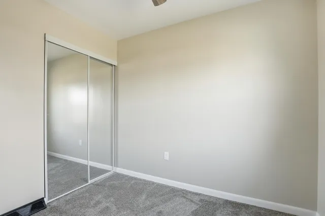 an empty room with closet area