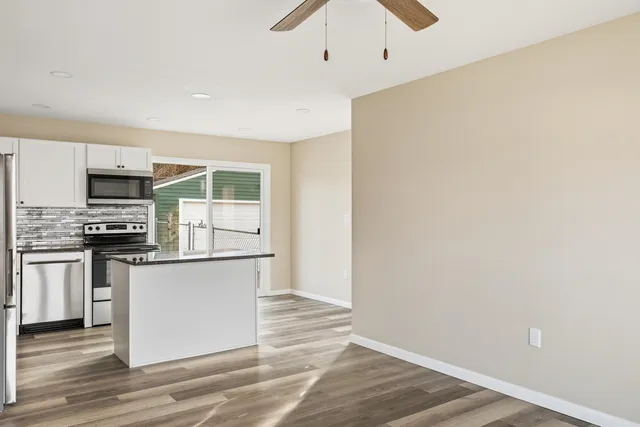 a kitchen with stainless steel appliances a refrigerator and a stove top oven