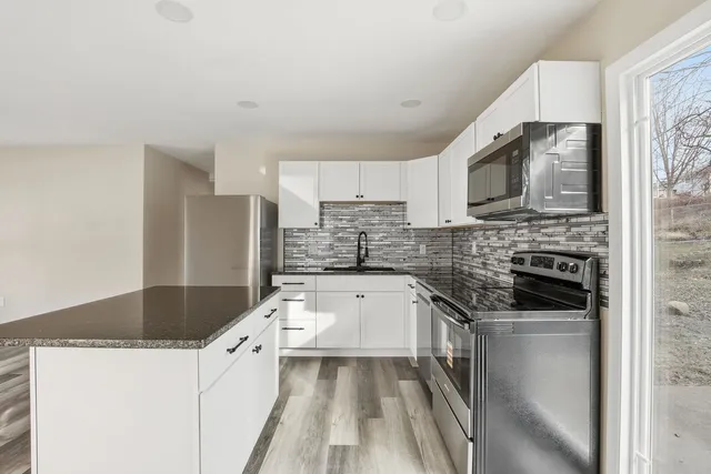 a kitchen with a sink stove and microwave
